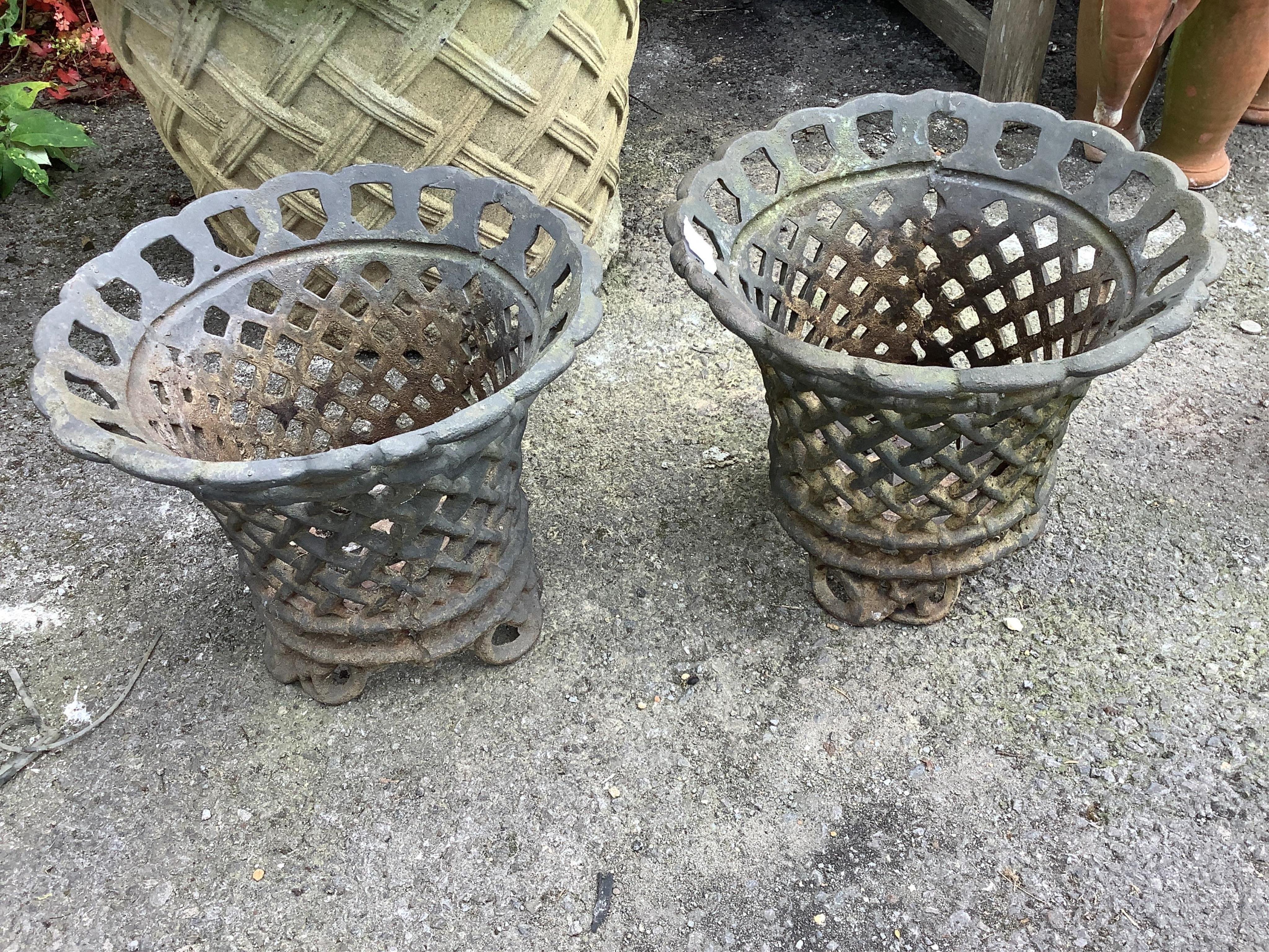 A pair of cast metal pot holders, diameter 35cm, height 30cm. Condition - good